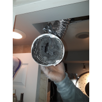 Clogged lint inside a dryer vent prior to cleaning. 